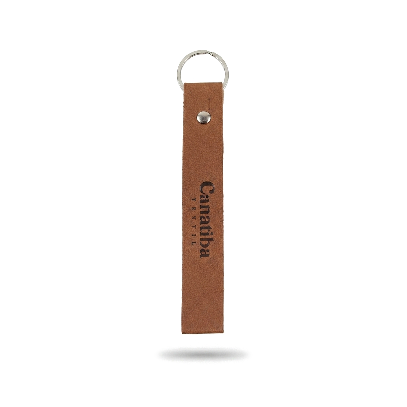 Chaveiro personalizado em couro sintético marrom na vertical, com argola metálica prateada no topo, rebite metálico e a gravação da marca 'Canatiba' em baixo relevo.