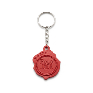 Chaveiro personalizado em formato redondo com acabamento vermelho em relevo, argola metálica no topo e design exclusivo.